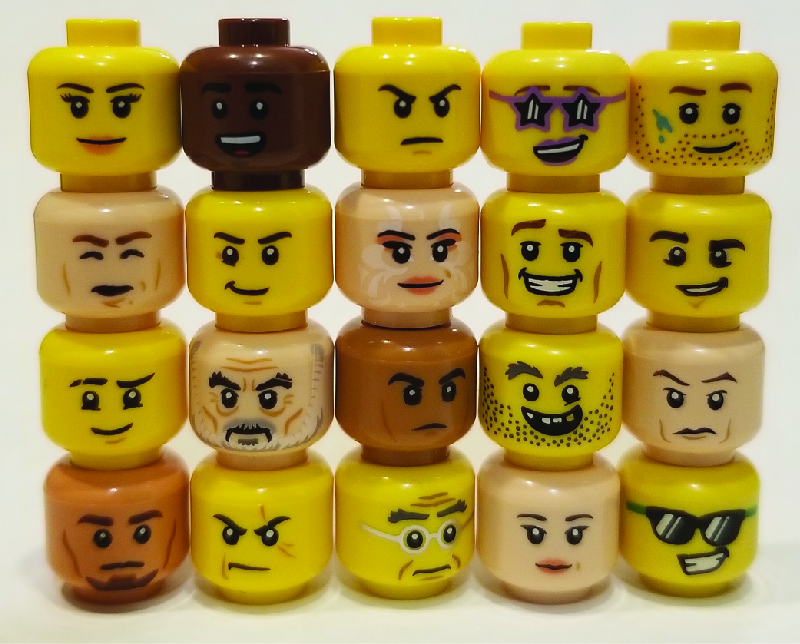 The image shows lego figure heads stacked in five columns, with four heads in each column. The heads show a variety of expressions.