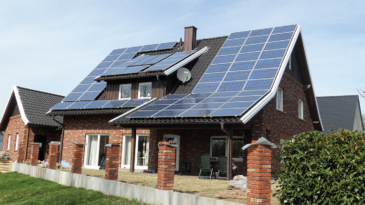A house with a roof covered with solar panels.