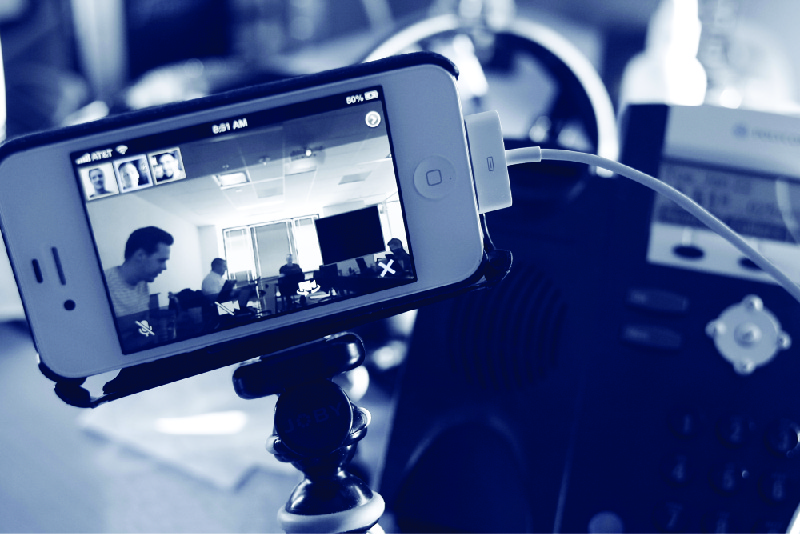 This photo shows a smartphone set up on a tripod for a video conference.